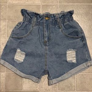 Never worn distressed denim shorts. Size: Medium